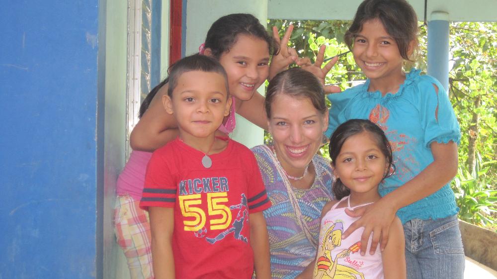 Volunteer surrounded with children